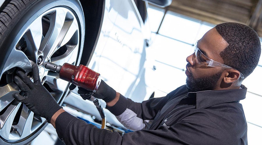 Service employee working on car tire